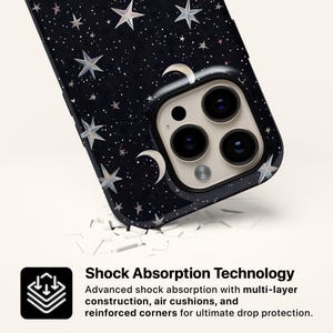 May include: A black phone case with a celestial design featuring stars and crescent moons. The case has a glossy finish and a camera cutout. The text on the image reads "Shock Absorption Technology" and describes the case's protective features.