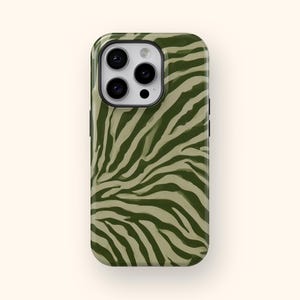 May include: A rectangular smartphone case featuring a dark olive green and light beige zebra stripe pattern. The case has a cutout at the top left corner for a triple-lens camera system, with a black border surrounding the camera module area.