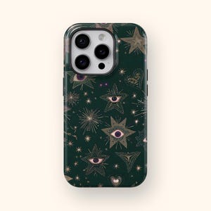 May include: A dark green phone case featuring a repeating pattern of gold stars, eyes, and hearts. The case has a glossy finish and a black border. The camera lenses are visible at the top.
