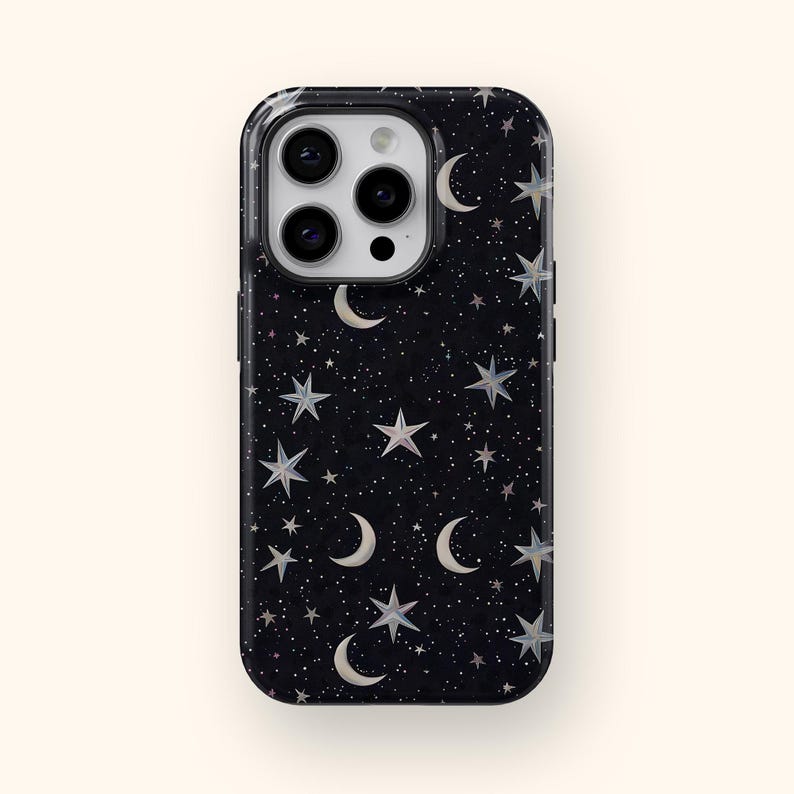 May include: Black phone case with a celestial design featuring white crescent moons, stars, and tiny dots. The case has a glossy finish and a rectangular shape with rounded corners. The camera lenses are visible at the top.