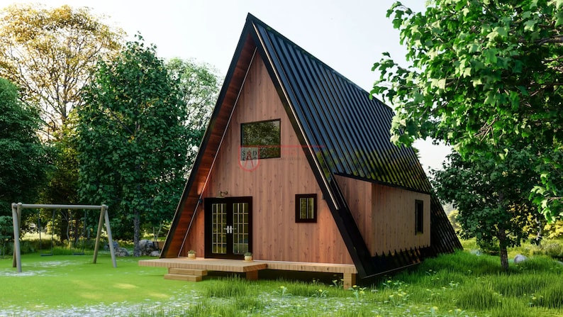 May include: An A-frame cabin with wood-paneled walls and a black metal roof. The structure features a front wooden deck, double glass doors with a grid pattern, and rectangular windows. A small red logo is visible on the front wall surface.