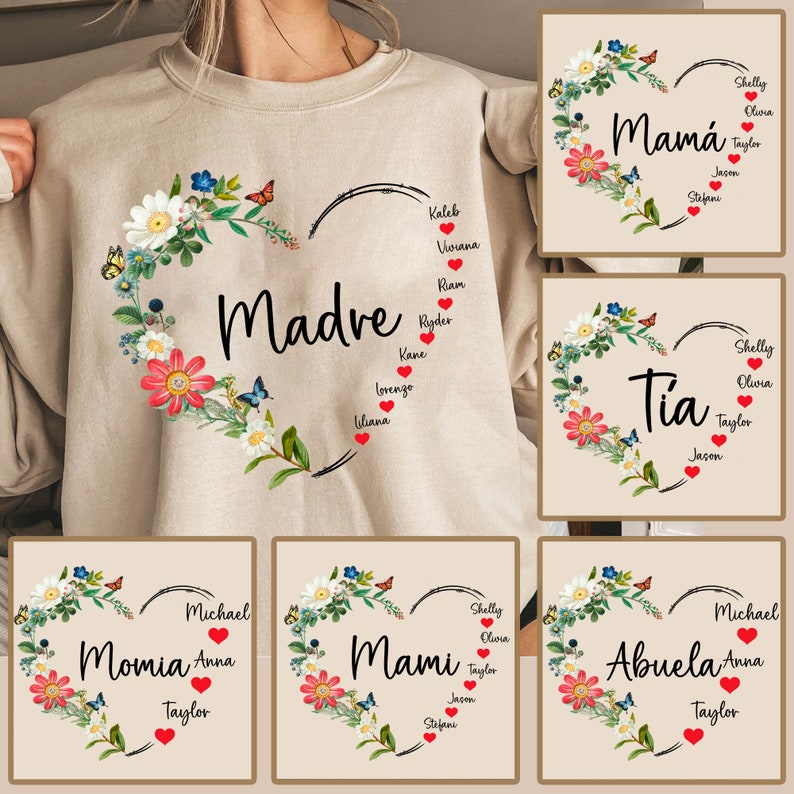 Puede incluir: Una sudadera beige con un dise&ntilde;o de coraz&oacute;n floral. El coraz&oacute;n tiene la palabra "Madre" en el centro y nombres de ni&ntilde;os alrededor. Otros dise&ntilde;os incluyen "Mami", "Momia", "Tia" y "Abuela" con diferentes nombres alrededor del coraz&oacute;n.