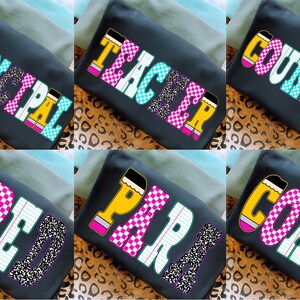 May include: A collection of six dark gray t-shirts with colorful text designs. Each shirt features a different word: "PRINCIPAL", "TEACHER", "COUNSELOR", "SPED", "PARAPRO", and "COACH". The text is in various patterns and colors, including pink, blue, and yellow.