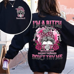 May include: Black sweatshirt with a graphic design featuring a woman with a skull bandana and sunglasses, roses, and the text "I'M A BITCH". The design also includes the phrases "Beautiful, Intelligent, Thoughtful, Caring, Honest", "With a low bullshit tolerance", and "Don't Try Me".