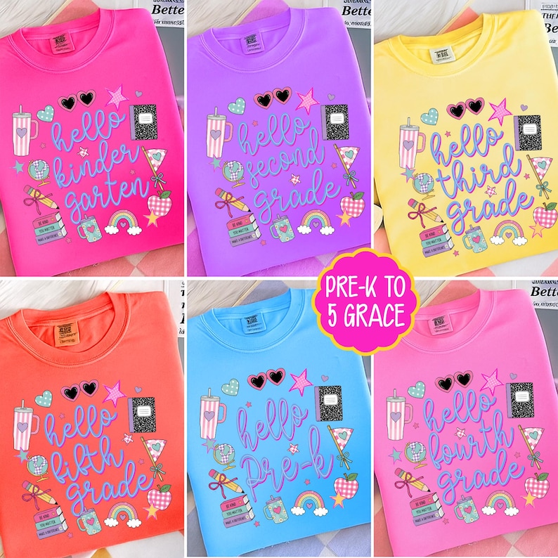 May include: A collection of six crewneck sweatshirts in pink, purple, yellow, orange, and blue, each featuring school-themed graphics including a notebook, pencil, globe, apple, and rainbow, with text reading hello kindergarten, second, third, fourth, fifth grade, or pre-k.