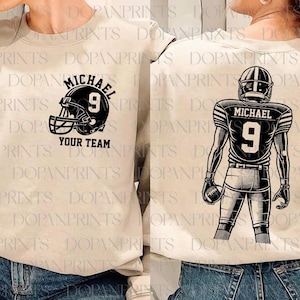 May include: A beige sweatshirt with a black and white football player graphic on the back. The graphic includes the text "Michael" and the number "9". The front of the sweatshirt has a black and white football helmet graphic with the text "Michael" and "Your Team".