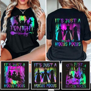 Puede incluir: Camisetas negras con gráficos coloridos. Una camiseta presenta el texto "TONIGHT We fly" con siluetas de brujas. Las otras camisetas muestran "IT'S JUST A bunch of HOCUS POCUS" con siluetas de brujas y una bruja volando en una escoba.