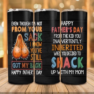 May include: Three black insulated tumblers with humorous text and graphics. One tumbler features an illustration of testicles and the text "Even though I'm not from your sack, I know you've still got my back. Happy Father's Day."