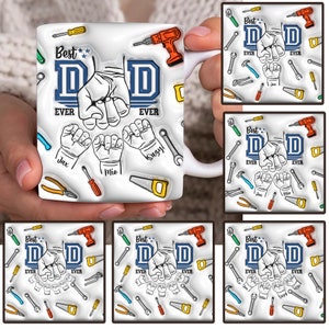 May include: White ceramic mug with a blue and white design that says "Best Dad Ever" with a graphic of hands making the sign for "I love you". The mug has a variety of tools printed on it, including hammers, wrenches, and saws.