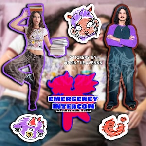 May include: A set of colourful stickers featuring cartoon characters and text. The stickers include a pink and blue cartoon character with a purple mohawk, a pink and blue cartoon character with a red heart, a purple cartoon character with a horn, and a pink and blue cartoon character with the text "Emergency Intercom Heaven by Marc Jacobs".
