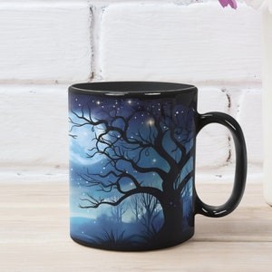 May include: Black ceramic mug with a dark blue and white design of a silhouetted tree with a full moon and stars in the background.