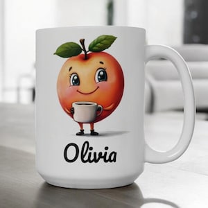 Puede incluir: Taza de cerámica blanca con un personaje de manzana de dibujos animados sosteniendo una taza pequeña. La manzana es naranja con hojas verdes y una cara sonriente. El nombre "Olivia" está impreso en escritura negra debajo.