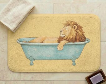 May include: A yellow bath mat with a lion relaxing in a blue bathtub. A white towel is placed on the mat, and a small wooden soap dish with a bar of soap is nearby. The mat is rectangular in shape.
