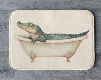 May include: A green alligator taking a bath in a white porcelain bathtub with ornate feet. The bathtub is on a cream-colored background.