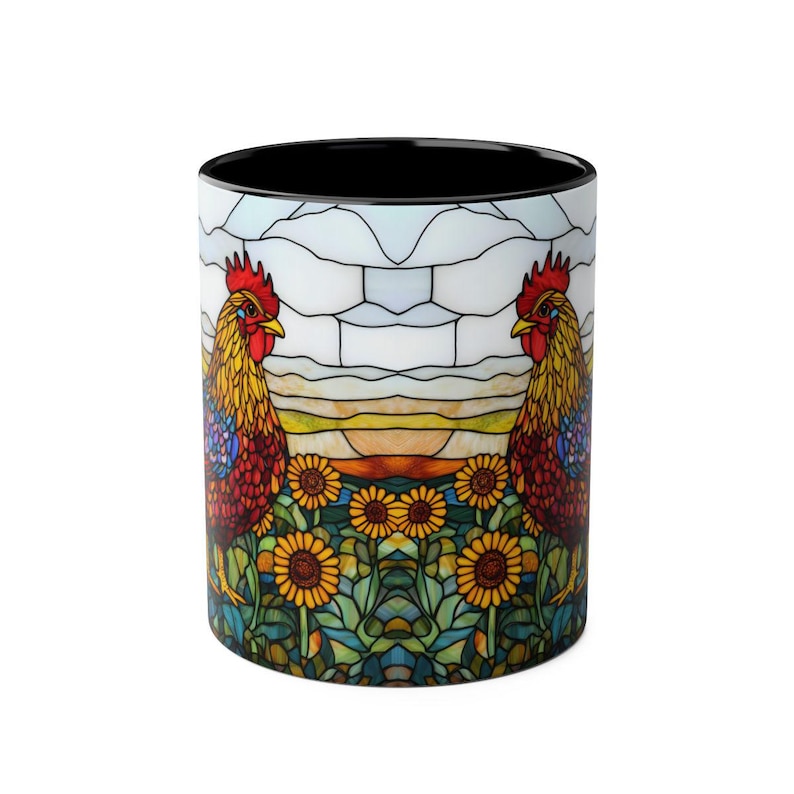May include: A ceramic coffee mug with a black interior and a colourful stained-glass design. The design features two roosters, sunflowers, and a sunset scene. The mug is approximately 9.5 cm tall.