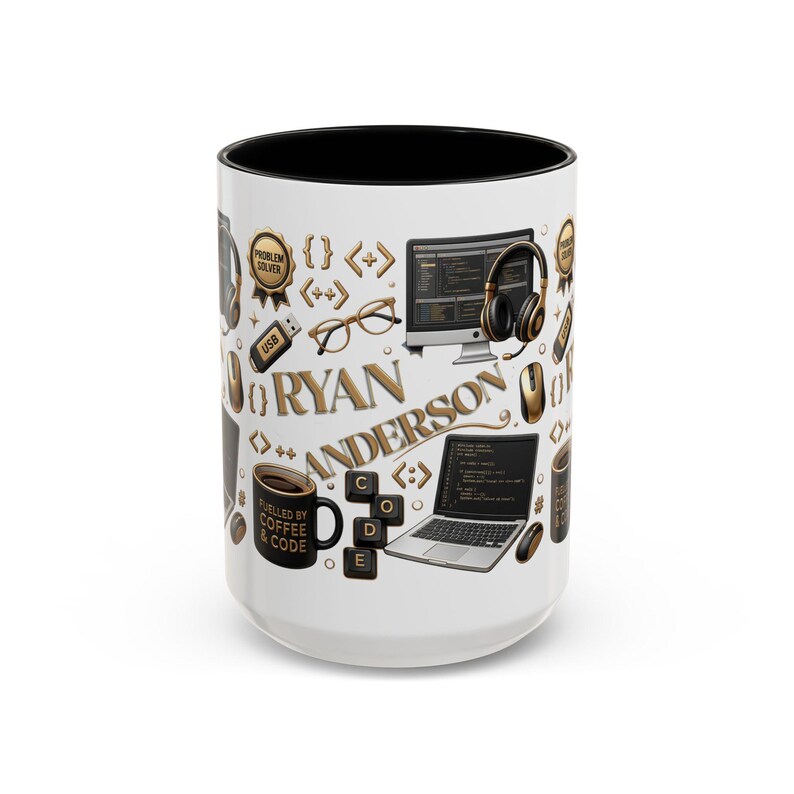 May include: A white ceramic mug with a black interior featuring a repeating pattern of computer-related icons including a laptop, monitor, headphones, glasses, USB drive, and keyboard keys. The name RYAN ANDERSON is printed in gold lettering.