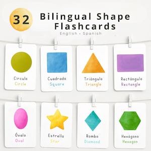 May include: A set of 32 bilingual shape flashcards in English and Spanish. Each card displays a different colored shape, such as a green circle, blue square, and orange triangle. The cards are hung with small white clips.