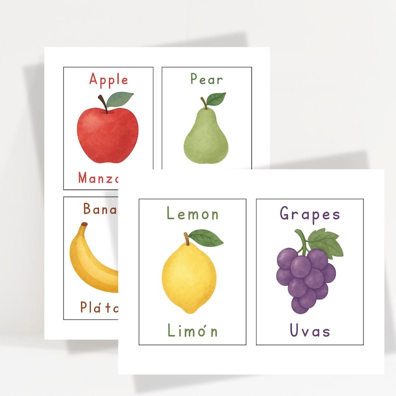 May include: Set of fruit flashcards featuring watercolor illustrations of an apple, pear, banana, lemon, and grapes. Each card has the fruit's name in English and Spanish. The cards are on a white background.