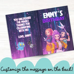 May include: A birthday card with a purple and blue background, featuring anime-style illustrations of three girls and the text "EMMY'S BIRTHDAY." The inside reads "YOU UNLEASHED THE MAGIC! THANKS FOR CELEBRATING WITH ME! LOVE, EMMY."