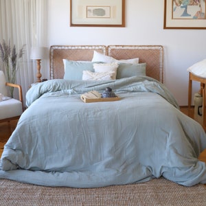 Turkish cotton muslin duvet cover in sage green, styled on king size bed in boho bedroom