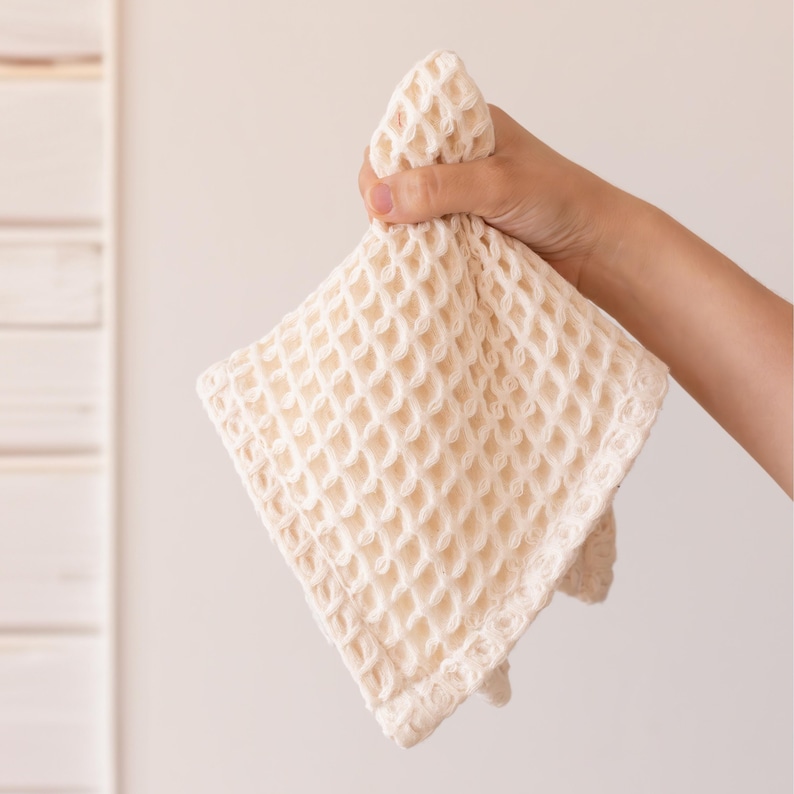 Hand holding soft soft waffle washcloth showing honeycomb texture — waffle face towel washcloth in OEKO-TEX Turkish cotton