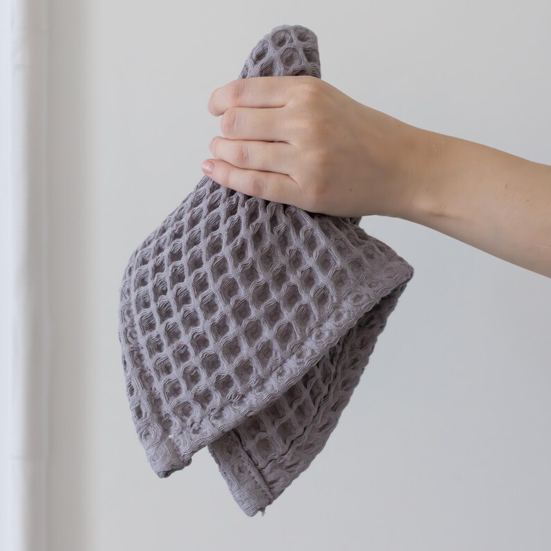Hand holding soft soft waffle washcloth showing honeycomb texture — waffle face towel washcloth in OEKO-TEX Turkish cotton
