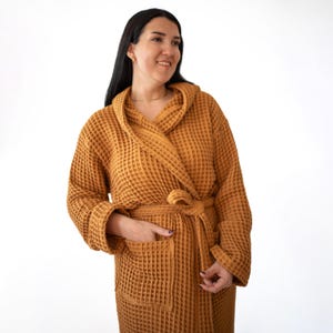 Close view of the caramel waffle housecoat with hand in pocket – elegant cotton waffle housecoat