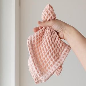Hand holding soft soft waffle washcloth showing honeycomb texture — waffle face towel washcloth in OEKO-TEX Turkish cotton