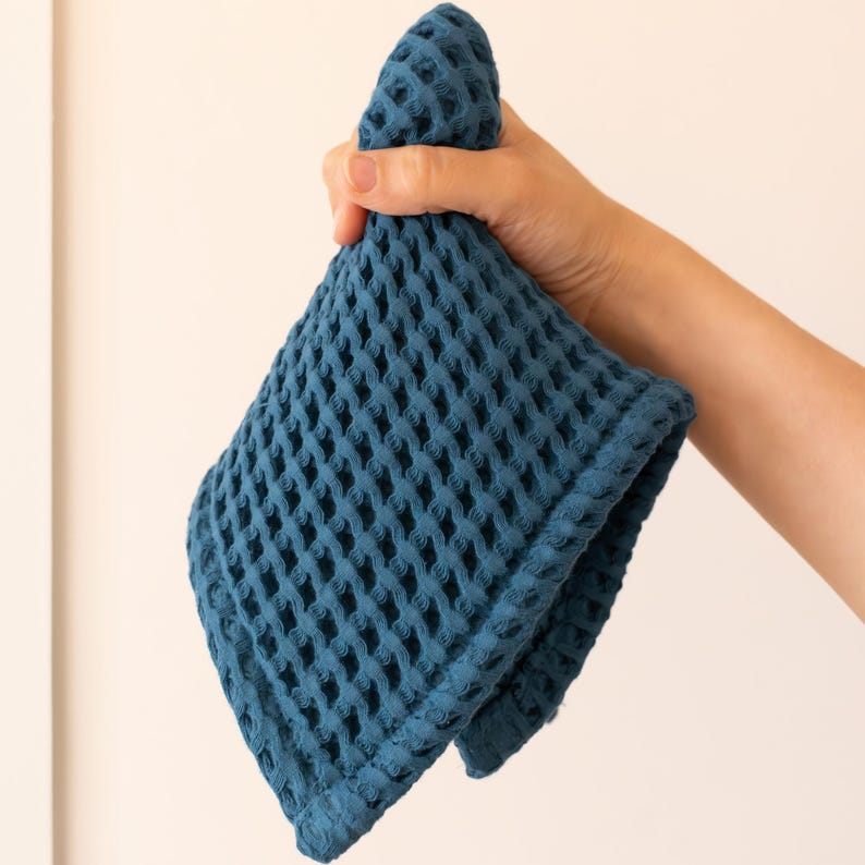 Hand holding soft soft waffle washcloth showing honeycomb texture — waffle face towel washcloth in OEKO-TEX Turkish cotton