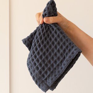 Hand holding soft soft waffle washcloth showing honeycomb texture — waffle face towel washcloth in OEKO-TEX Turkish cotton