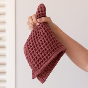 Hand holding soft soft waffle washcloth showing honeycomb texture — waffle face towel washcloth in OEKO-TEX Turkish cotton