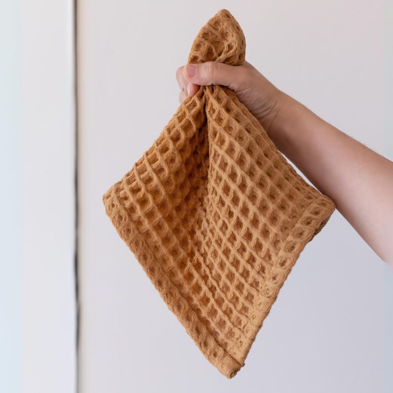Hand holding soft soft waffle washcloth showing honeycomb texture — waffle face towel washcloth in OEKO-TEX Turkish cotton