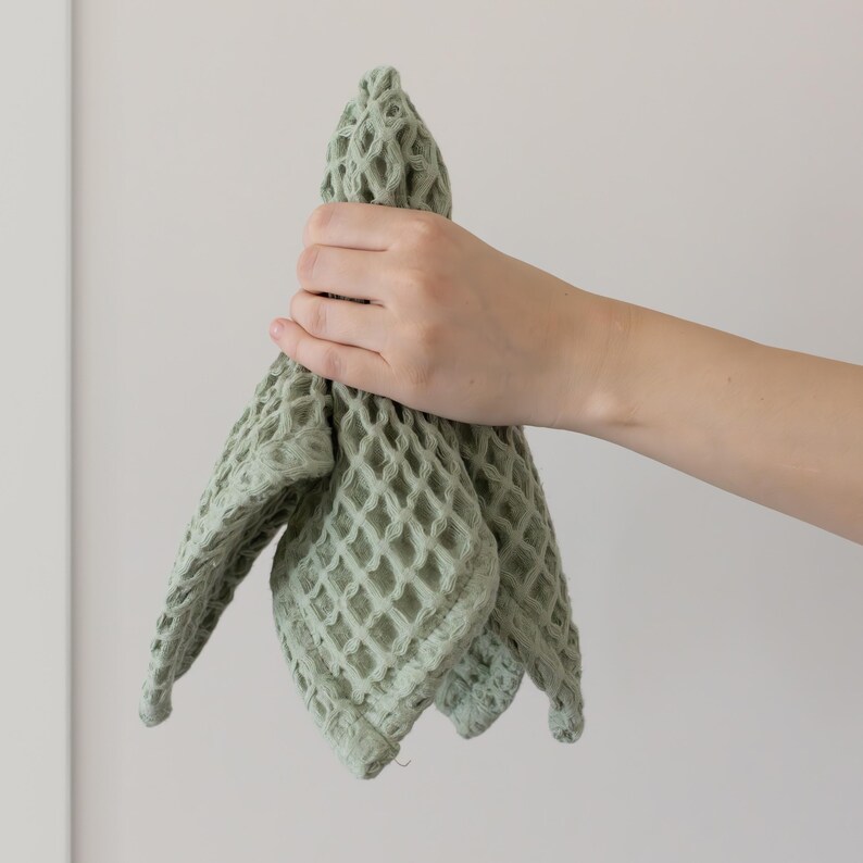 Hand holding soft soft waffle washcloth showing honeycomb texture — waffle face towel washcloth in OEKO-TEX Turkish cotton