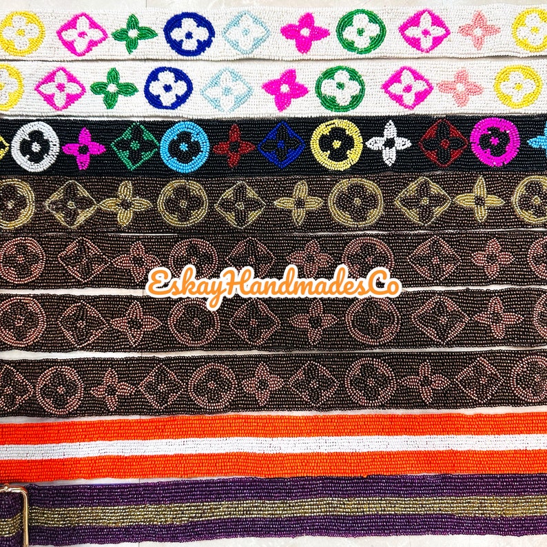 May include: A collection of beaded trim featuring a repeating pattern of the Louis Vuitton logo. The trim is available in a variety of colours, including black, brown, white, and orange. The trim is perfect for adding a touch of luxury to any project.