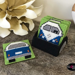 May include: Set of four green and blue canvas coasters with a white and gray vintage van design. The coasters are in a black holder.