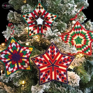 May include: Four colorful star-shaped ornaments with geometric patterns in red, green, white, purple, and yellow. The ornaments are hanging on a Christmas tree.