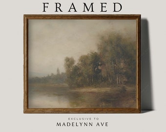 May include: A framed painting of a landscape scene with a river, trees, and a distant village. The painting is in a brown wooden frame.