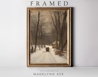 May include: Framed vintage winter landscape art print. The artwork shows a snowy road with a horse-drawn carriage, bare trees, and a small building. The frame is gold-coloured, and the text "FRAMED" is at the top.