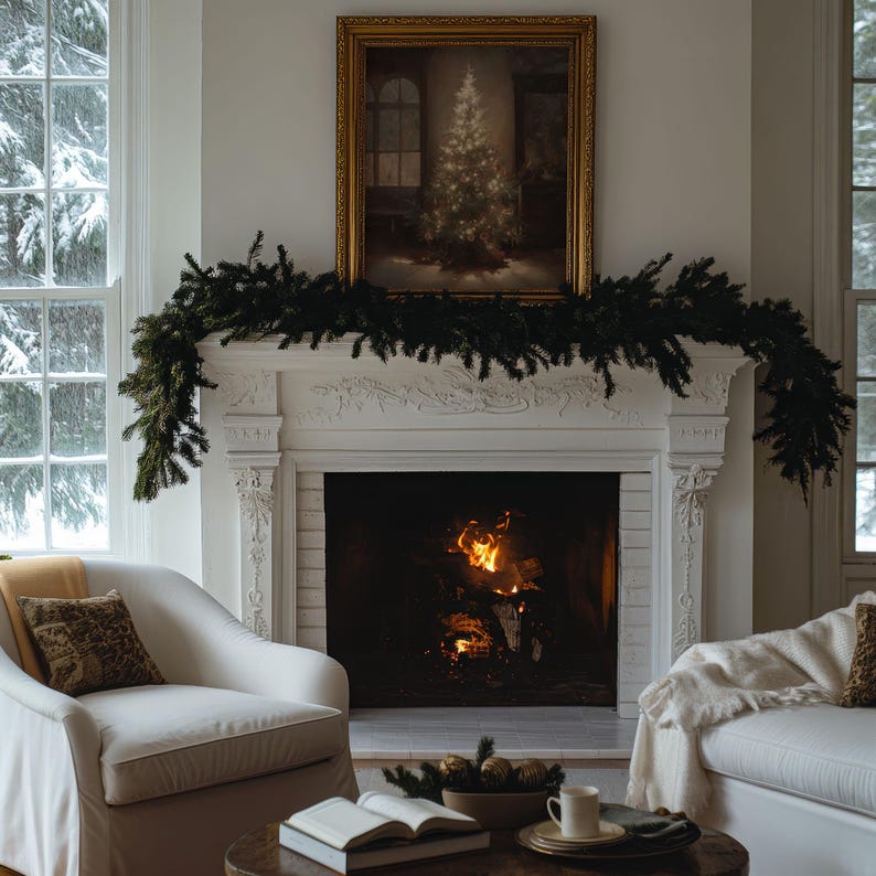 May include: A white fireplace with a roaring fire inside. A green garland is draped across the mantelpiece, and a framed painting of a snowy forest scene hangs above the fireplace.