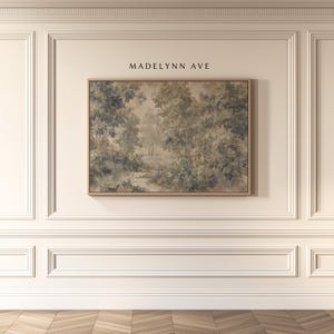 May include: A framed landscape painting with a muted color palette of greens, blues, and browns. The artwork depicts a forest scene with trees and a path. The text "MADELYNN AVE" is above the painting.