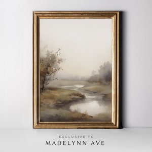 May include: A watercolor painting of a misty landscape with a winding river and a lone tree in the foreground. The painting is framed in a gold frame.