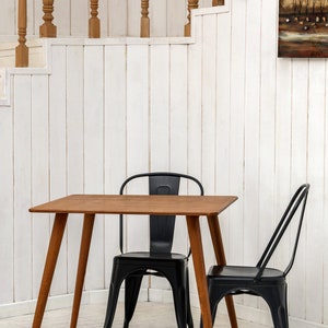 Here is Square Walnut Wooden Dining Room Table! This Narrow Space Dine Table Kitchen in the dining room perfectly complements and change the cozy small home atmosphere, offering a personalized touch to the kitchen.