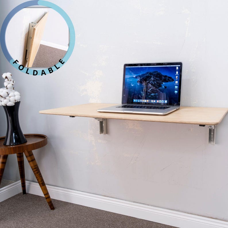 Here is Wall Mounted Foldable Home Office Desk Table! This Fold Down Small Space Saving Laptop Desk in the home office, balcony or kitchen perfectly complements the cozy atmosphere, offering a personalized touch to the workspace.