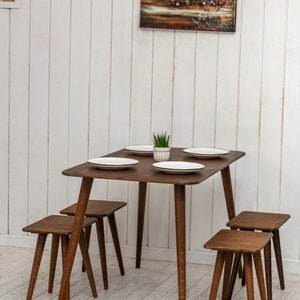🍽️ Space Saving Rectangle Narrow Small Dining Table Set – Walnut Wood Bench & Stool Kitchen Set

Maximize your space without compromising style with this rectangle small dining table set. Crafted from warm walnut wood, this wooden dine table set combines modern minimalist design with rustic charm, making it perfect for small kitchens, breakfast nooks, and dining areas.

✨ Why You’ll Love It:

Sleek and minimalist rectangular dining table blends modern aesthetics with handcrafted warmth.