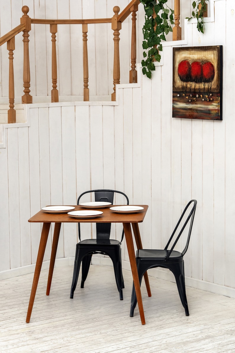 Here is Square Walnut Wooden Dining Room Table! This Narrow Space Dine Table Kitchen in the dining room perfectly complements and change the cozy small home atmosphere, offering a personalized touch to the kitchen.
