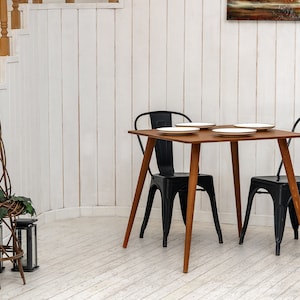 Here is Square Walnut Wooden Dining Room Table! This Narrow Space Dine Table Kitchen in the dining room perfectly complements and change the cozy small home atmosphere, offering a personalized touch to the kitchen.