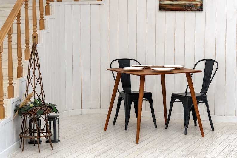 Here is Square Walnut Wooden Dining Room Table! This Narrow Space Dine Table Kitchen in the dining room perfectly complements and change the cozy small home atmosphere, offering a personalized touch to the kitchen.