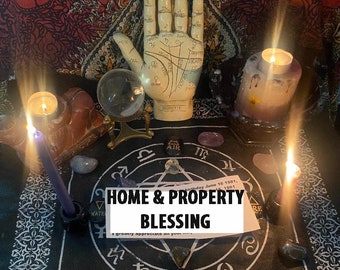 May include: A black and white circular design with astrological symbols and gemstones. A hand with lines drawn on it is in the center of the design. There are three candles, a crystal ball, and a card that says "HOME & PROPERTY BLESSING" on top of the design.