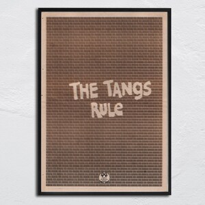 May include: Framed art print with a brick wall pattern in shades of brown. The text "THE TANGS RULE" is in white, stylized lettering. A small emblem is at the bottom. The artwork is in a black frame.