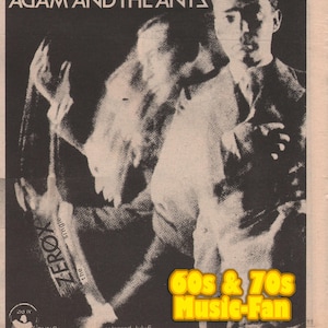 May include: Black and white vintage poster for Adam and the Ants, featuring a blurred image of a person. The text "ADAM AND THE ANTS" is at the top. The poster also includes the text "ZEROX the single" and "60s & 70s Music-Fan".